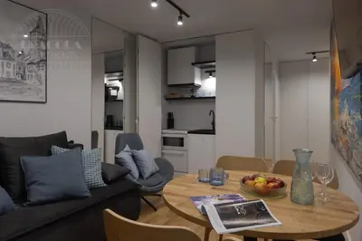 a living room with a table and a couch at Cityscape Fragola Apartments in Kraków
