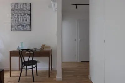 a room with a desk and a chair next to a door at Cityscape Fragola Apartments in Kraków