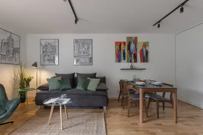 a living room with a couch and a table at Cityscape Fragola Apartments in Kraków