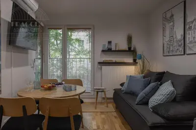 a living room with a couch and a table at Cityscape Fragola Apartments in Kraków