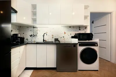 a room with white doors and a table and chairs at Roomy apartments Łobzowska Street in Kraków