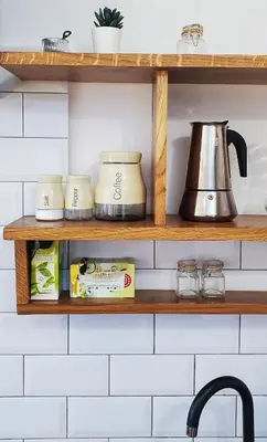 a kitchen shelf with spices and a tea kettle at Old Town Parkview Apartment in Kraków