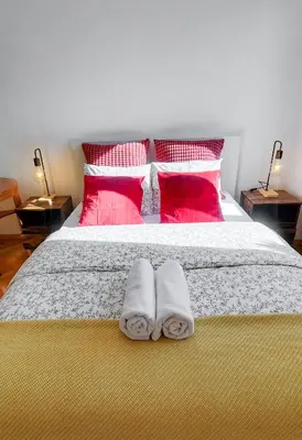 a bedroom with a bed with two towels on it at Old Town Parkview Apartment in Kraków