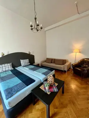 a bedroom with a large bed and a couch at Old Town Apartments in Kraków