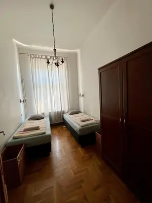 a room with two beds and a window at Old Town Apartments in Kraków