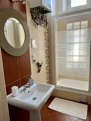a bathroom with a sink and a mirror at Old Town Apartments in Kraków