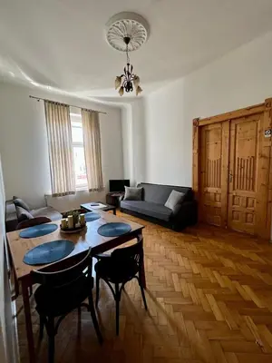 a living room with a table and a couch at Old Town Apartments in Kraków