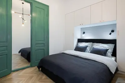 a bedroom with a bed and a green door at Kazimierz - Starowiślna 41 street in Kraków