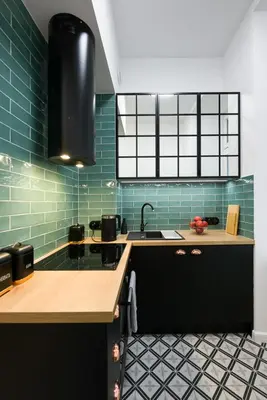 a kitchen with green tiles and a sink at Kazimierz - Starowiślna 41 street in Kraków