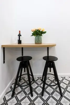 a table with two bar stools and a bottle of wine at Kazimierz - Starowiślna 41 street in Kraków