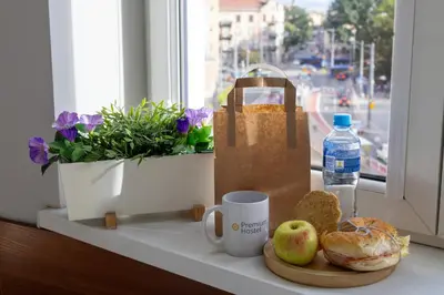 a table with a bag of bread and a cup of coffee at Freedom Hostel in Kraków