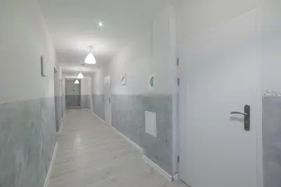 an empty hallway with a door at Freedom Hostel in Kraków