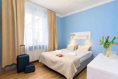 a hotel room with a bed and a suitcase at Freedom Hostel in Kraków