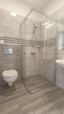 a bathroom with a shower and a toilet and a sink at Freedom Hostel in Kraków