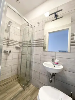 a bathroom with a shower and a sink and a toilet at Freedom Hostel in Kraków