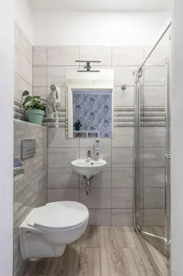 a bathroom with a toilet and a sink and a shower at Freedom Hostel in Kraków
