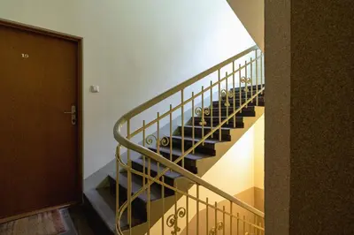 a set of stairs in a building with a door at Marylin Studio - Czysta 5 Street in Kraków