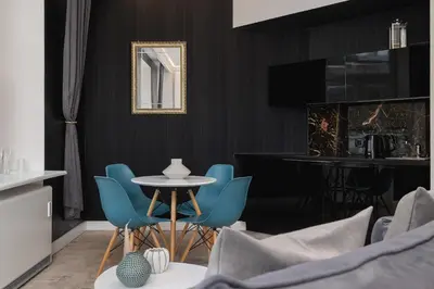 a dining room with blue chairs and a table at Marylin Studio - Czysta 5 Street in Kraków