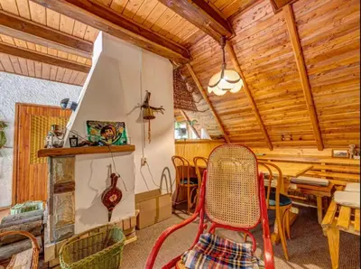 a dining room with a table and chairs at Klimatyczny domek w górach in Sordelówka
