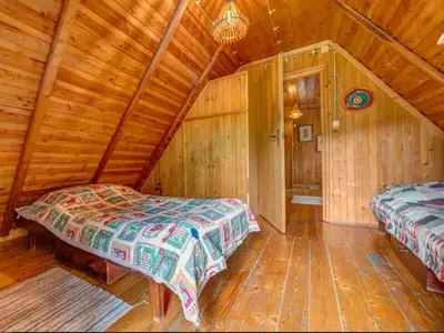 a bedroom with two beds in a wooden cabin at Klimatyczny domek w górach in Sordelówka
