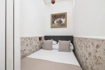 a bed in a room with a wall with flowers at 2 bedroom apartment - Sereno Fenn'a 5 street in Kraków