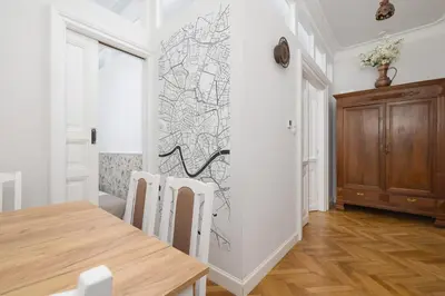 a dining room with a table and a wall at 2 bedroom apartment - Sereno Fenn'a 5 street in Kraków