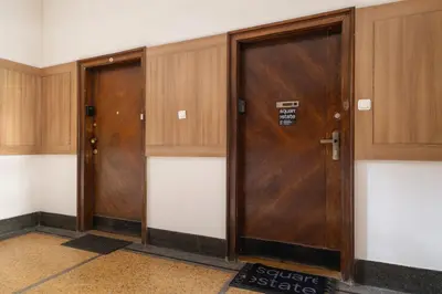 two wooden elevators in a room with wooden doors at 2 bedroom apartment - Sereno Fenn'a 5 street in Kraków