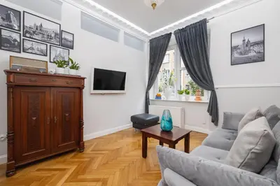 a living room with a couch and a tv at 2 bedroom apartment - Sereno Fenn'a 5 street in Kraków