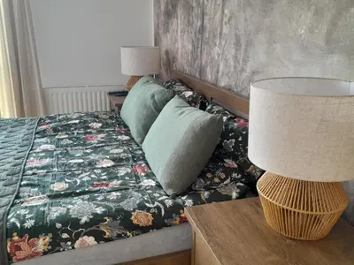 a bedroom with a bed and a table with a lamp at Old Town Premium Apartment in Kraków