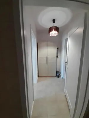an empty hallway with a door and a light at Old Town Premium Apartment in Kraków