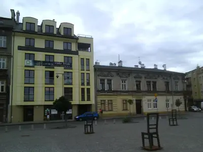 a yellow building with a blue car parked in front of it at Old Town Premium Apartment in Kraków