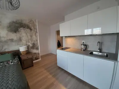 a kitchen with white cabinets and a sink at Old Town Premium Apartment in Kraków