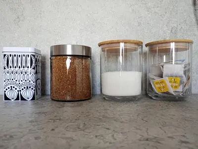 a group of three jars with spices and milk at Old Town Premium Apartment in Kraków