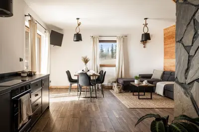 a living room with a couch and a table at Mokosz in PyzÃ³wka
