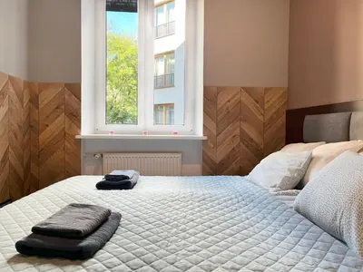 a bedroom with a bed with two towels on it at Comfy Apartment with home cinema projector, Cracow's heart in Kraków