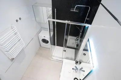 a white bathroom with a shower and a toilet at Apartment with Air Conditioning in the heart of Cracow heart in Kraków