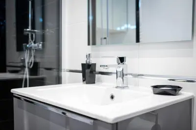 a bathroom with a white sink and a mirror at Apartment with Air Conditioning in the heart of Cracow heart in Kraków