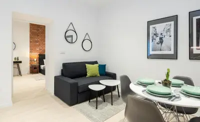 a living room with a table and a chair at Apartment with Air Conditioning in the heart of Cracow heart in Kraków