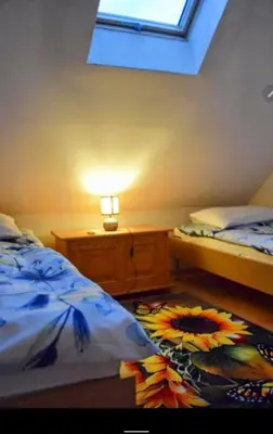 a bedroom with two beds and a lamp and a window at Salt Mine Apartment Bochnia by OTH in Bochnia
