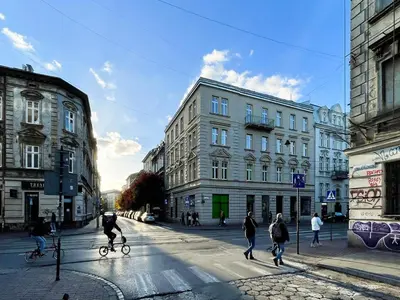 a group of people crossing a street in a city at S45 APT by PROMODERO in Kraków