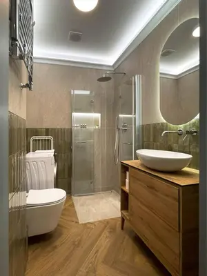 a bathroom with a sink and a toilet and a mirror at S45 APT by PROMODERO in Kraków
