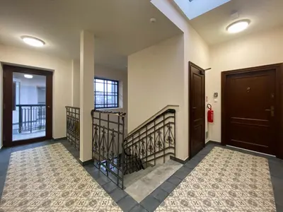 a hallway with two doors and a staircase at S45 APT by PROMODERO in Kraków