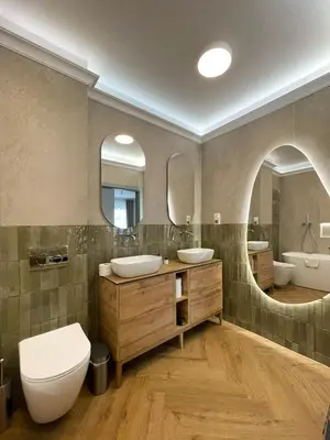 a bathroom with two sinks and two mirrors at S45 APT by PROMODERO in Kraków