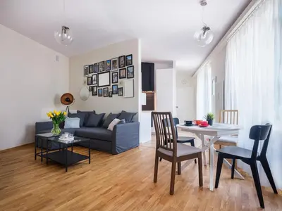 a living room with a couch and a table at Tyzenhauz Apartments Kazimierz in Kraków