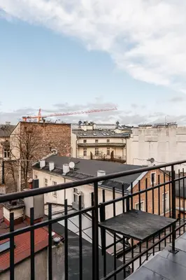 a view of a city from a balcony at Tyzenhauz Apartments Kazimierz in Kraków