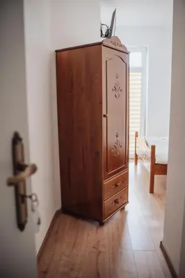 a wooden cabinet in a room with a floor at Zajazd Hetmański-Noclegi-Nowy Wiśnicz in Nowy Wiśnicz
