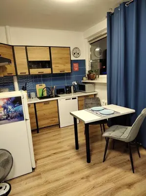 a small kitchen with a table and a table and chairs at Star Wars Climate Apartment in Kraków