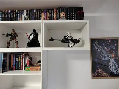 a white book shelf filled with toys and books at Star Wars Climate Apartment in Kraków