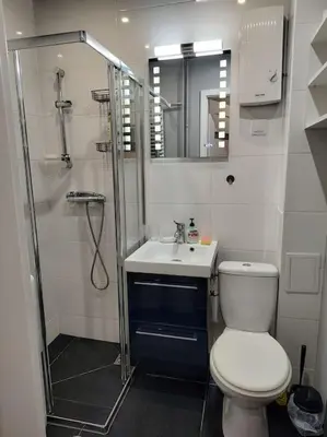 a bathroom with a shower and a toilet and a sink at Star Wars Climate Apartment in Kraków