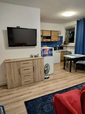 a living room with a flat screen tv on the wall at Star Wars Climate Apartment in Kraków